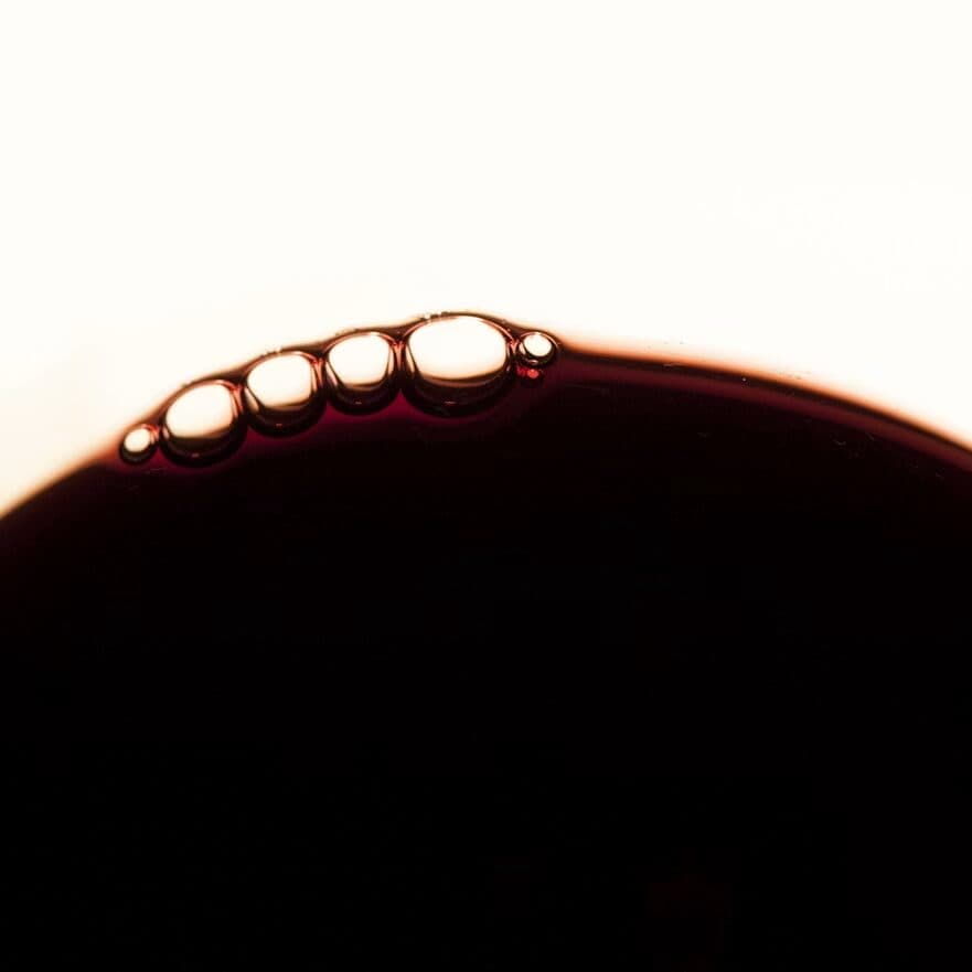 Close-up of the surface of a glass of mature red wine